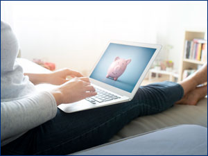 person sitting while working on laptop