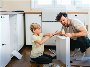 man and child building a drawer