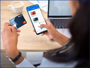 woman holding RBFCU Mastercard credit card