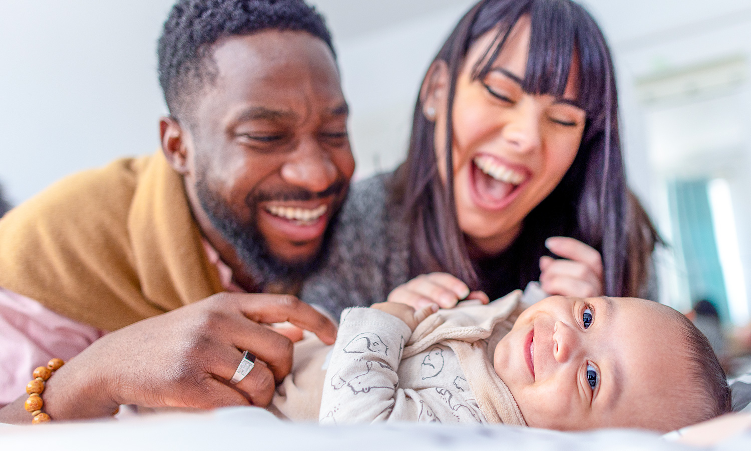 Couple smiling at baby