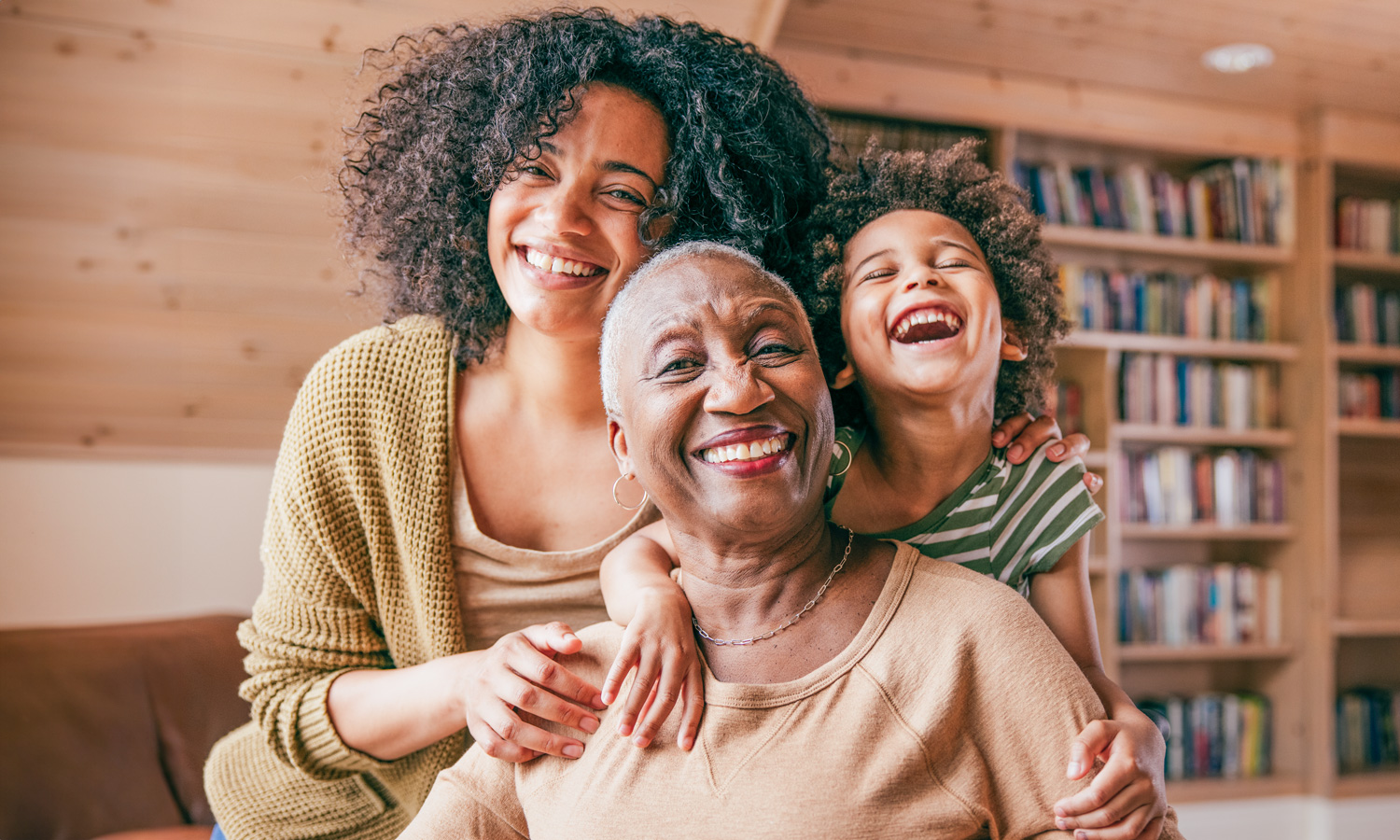 Grandmother, mother and child smiling together.