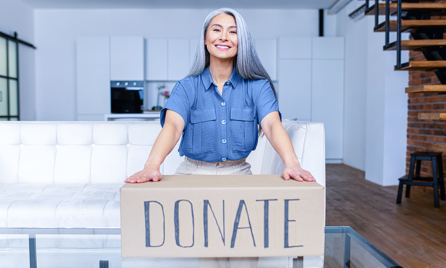 Woman with box labeled Donate