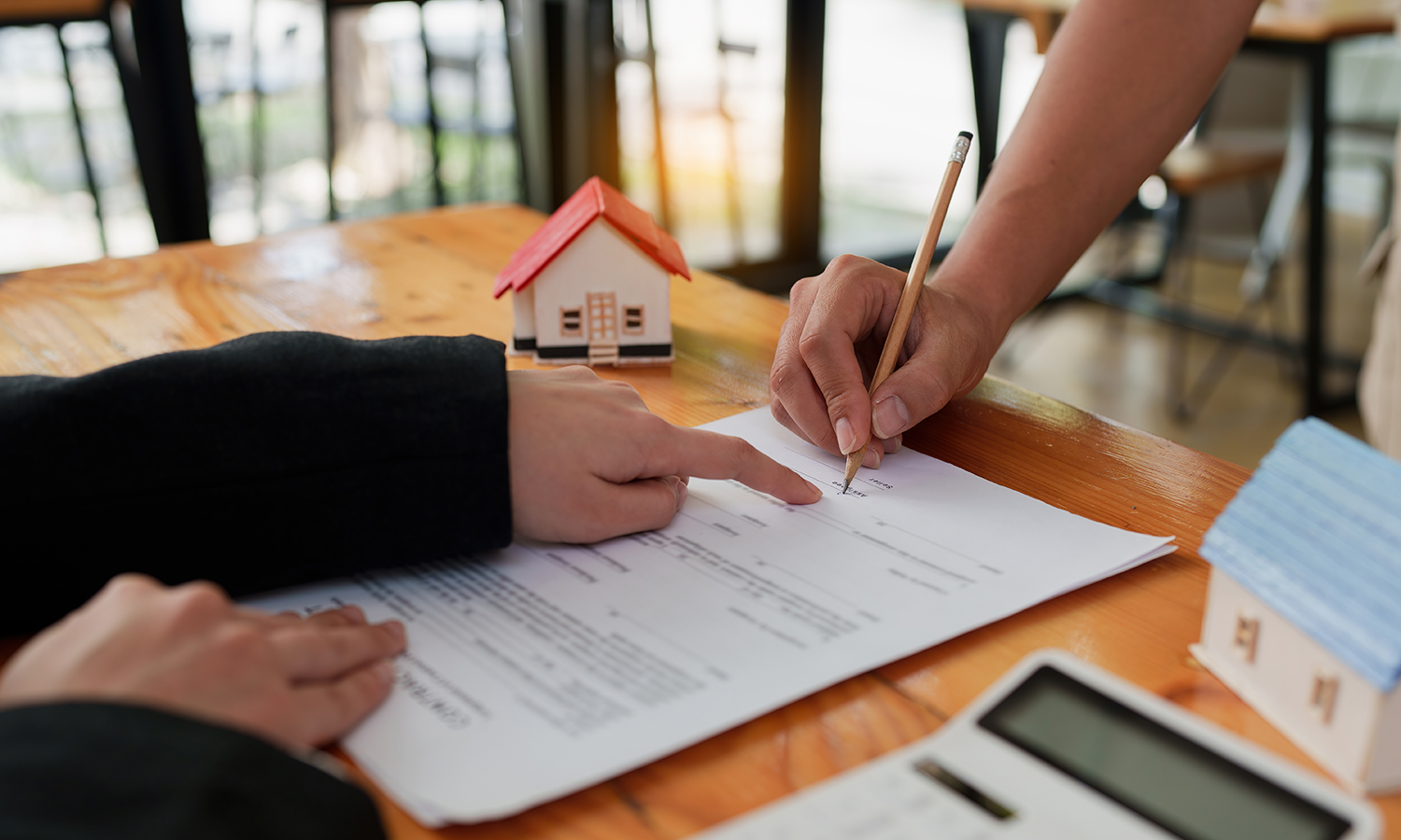 Person signing papers for closing on a home