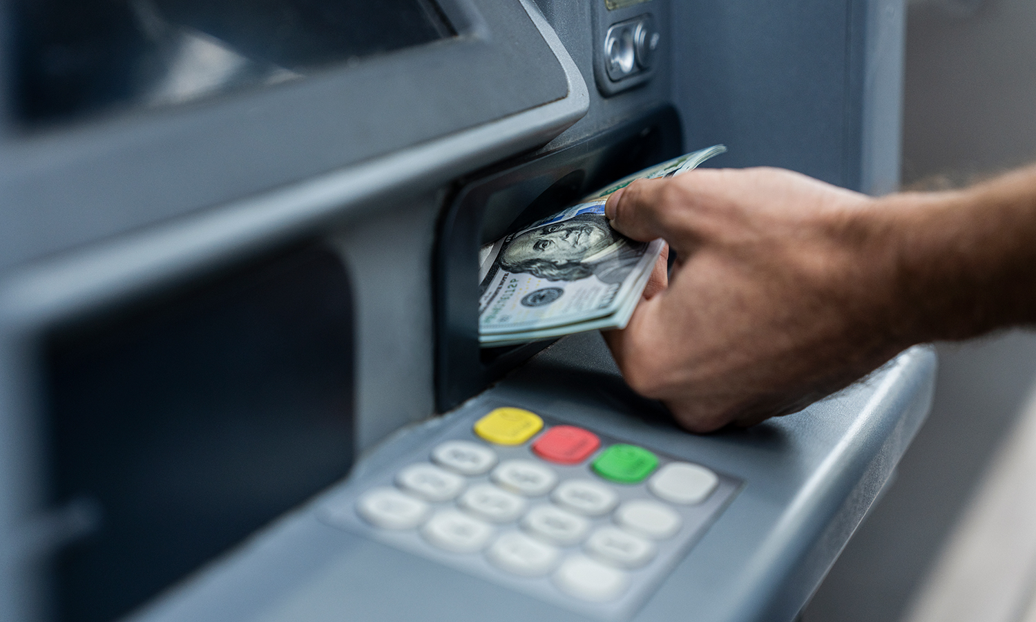 Man making cash deposit at ATM