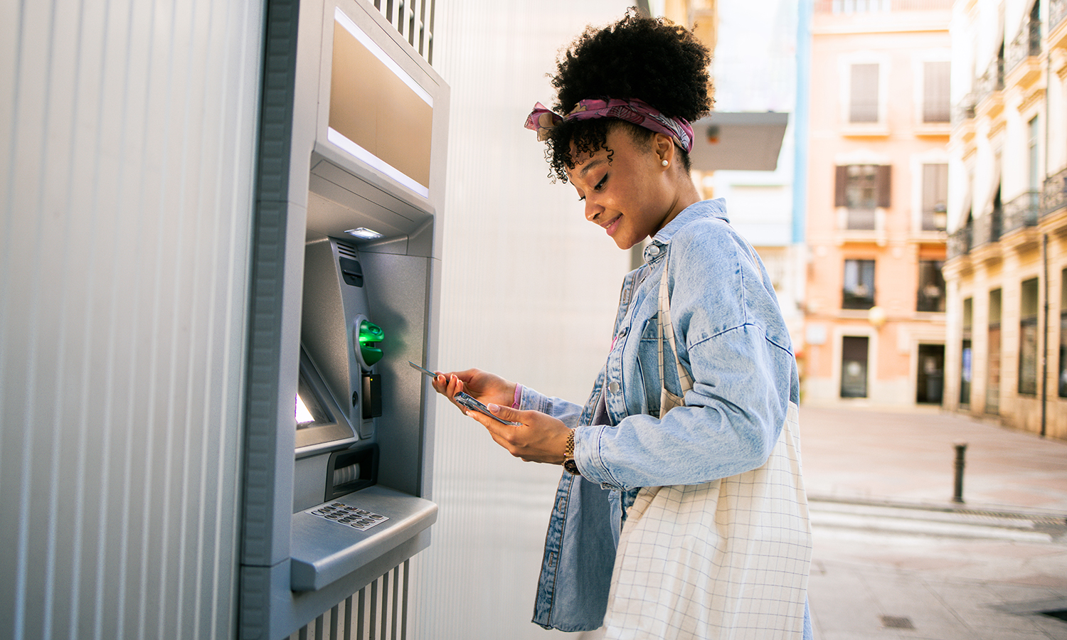 Woman using ATM machine