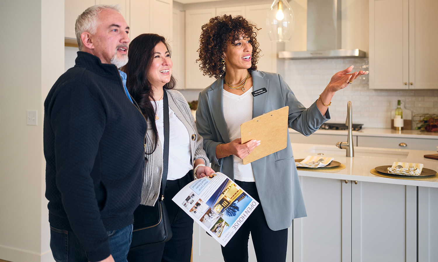 Man and woman looking at house with real estate agent