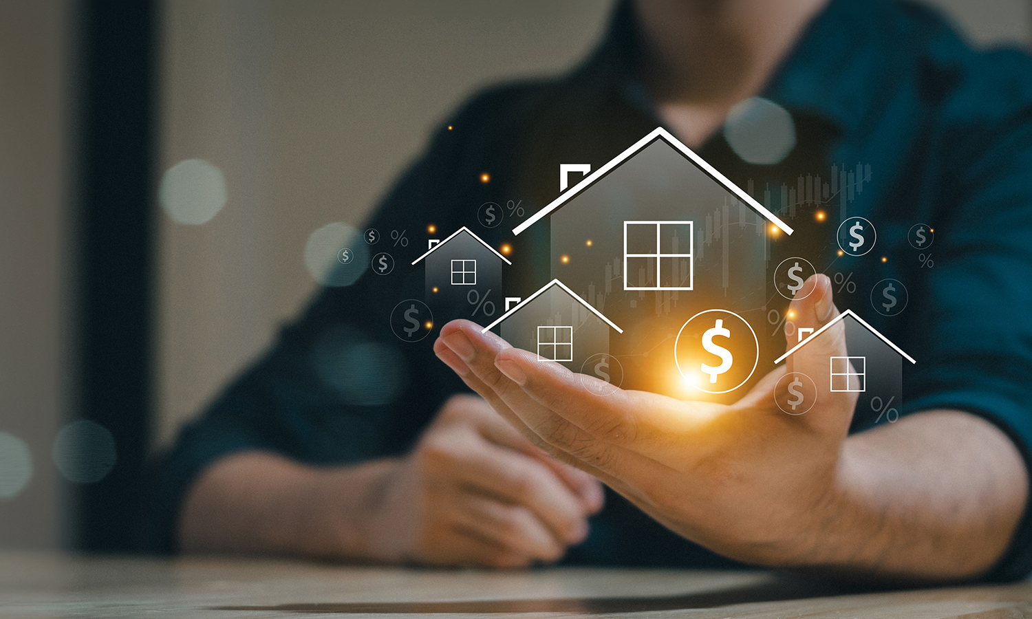 House with dollar signs hologram in man's hand