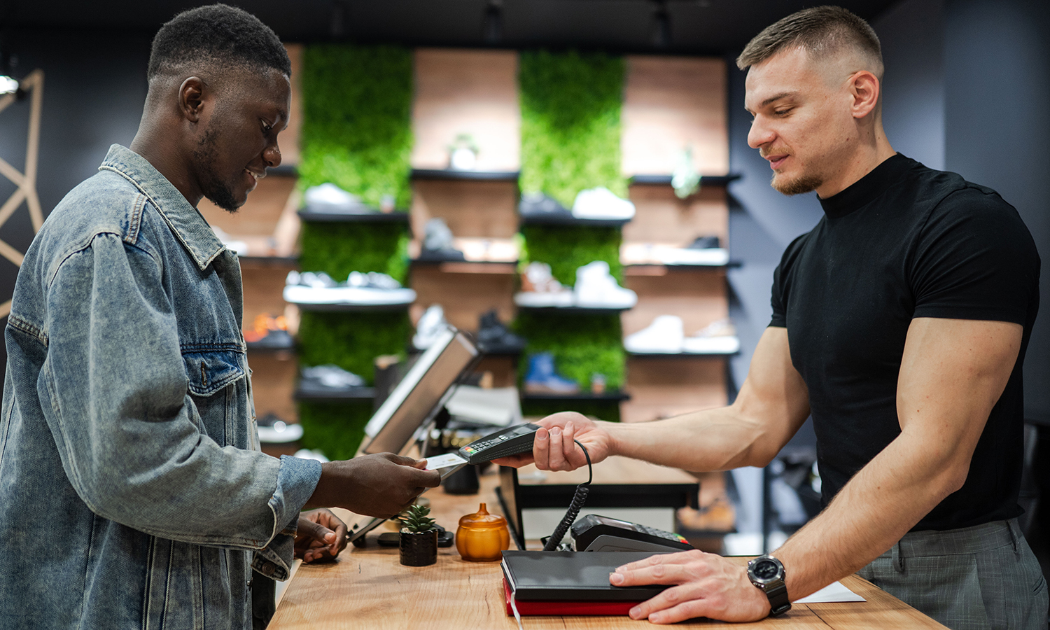 Man making credit card purchase at sneaker store