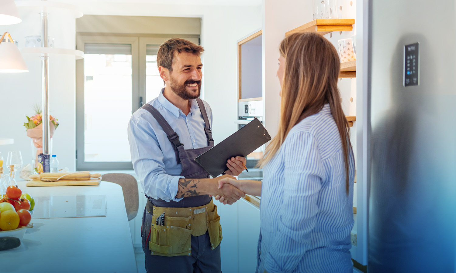 man holding clipboard and shakes woman's hand