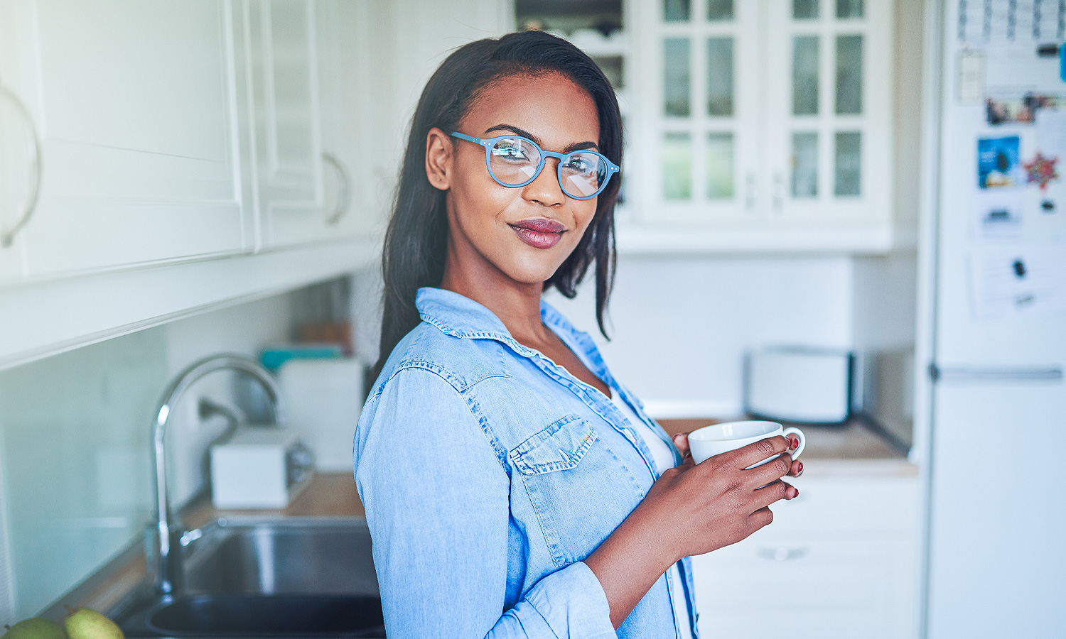 woman standing in the kitchen holding a mug