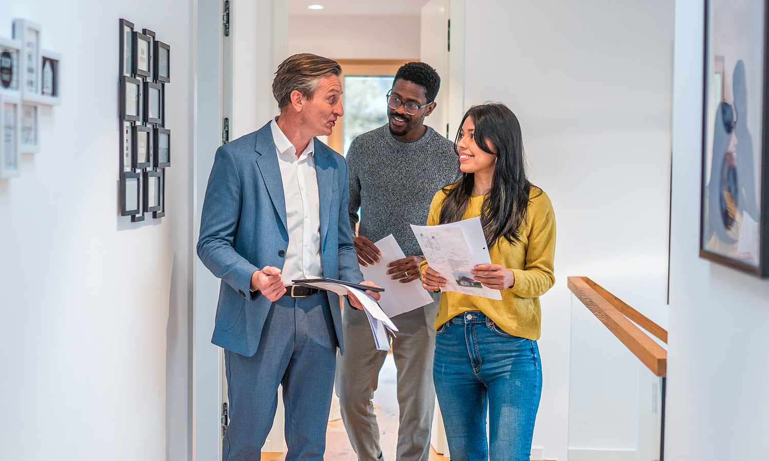 Real estate agent showing house to man and woman