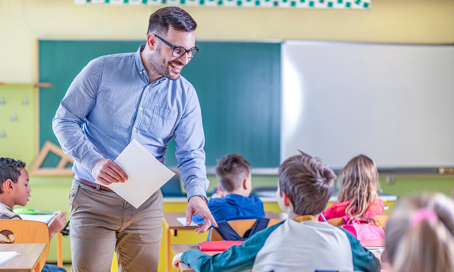 Teacher smiling at student