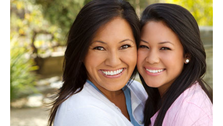 Woman and daughter smiling for the camera